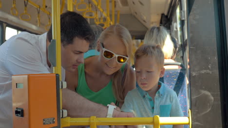 child using fathers smartwatch during bus ride