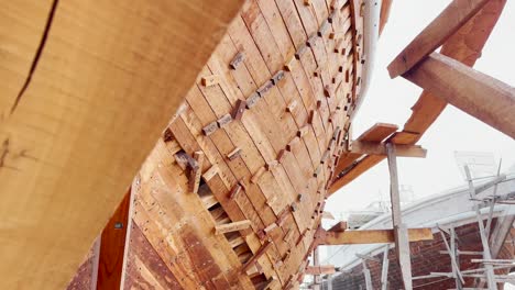 Low-Angle-View-Of-Traditional-Wooden-Boat-In-Dry-Dock-At-Ibrahim-Hyderi,-Karachi