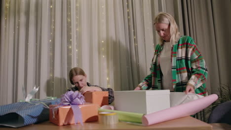 mother and daughter wrapping christmas presents