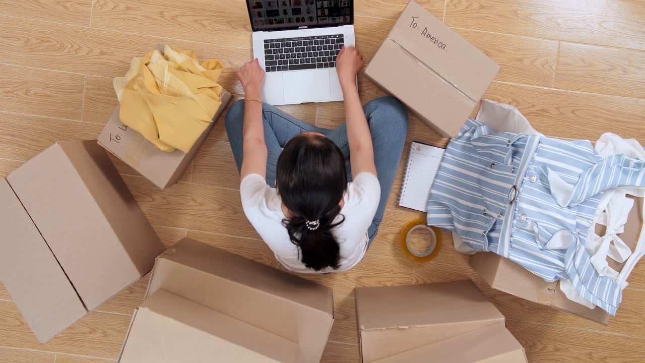 Top View Of Young Asian Small Business Owner Carrying Dress
