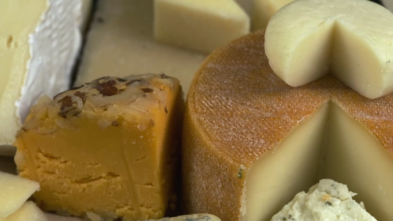 Brie, Chevre, Blue, Swiss, Cheddar, and Oka cheeses on rotating view
