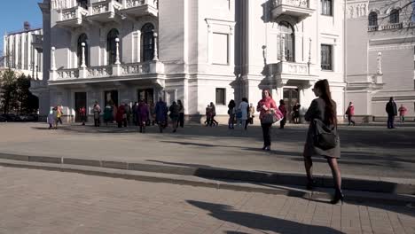 people gathered outside a grand building