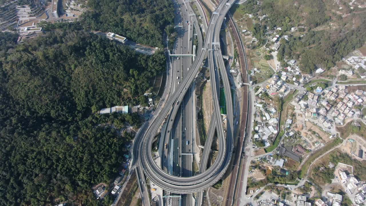Traffic on a Massive highway interchange with multiple levels and loop shaped road in Hong Kong, Aerial view