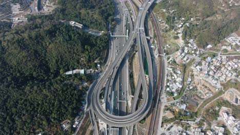 Traffic-on-a-Massive-highway-interchange-with-multiple-levels-and-loop-shaped-road-in-Hong-Kong,-Aerial-view