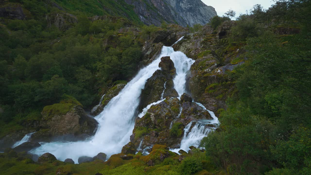 Briksdalsbreen glacier waterfall, Norway. Water rushing down a cascade in Scandinavia. Landscape nature