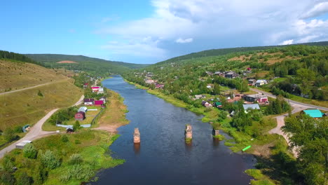 aerial view of a river and village in a forest landscape