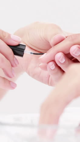 woman getting a manicure at nail salon