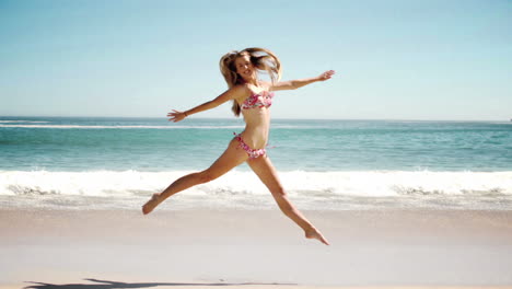 happy young woman jumping on beach in cinemagraph