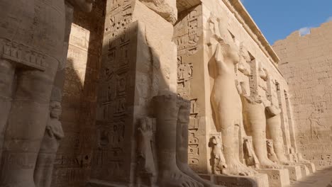 ancient egyptian wall reliefs and inscriptions - medinet habu, luxor, egypt