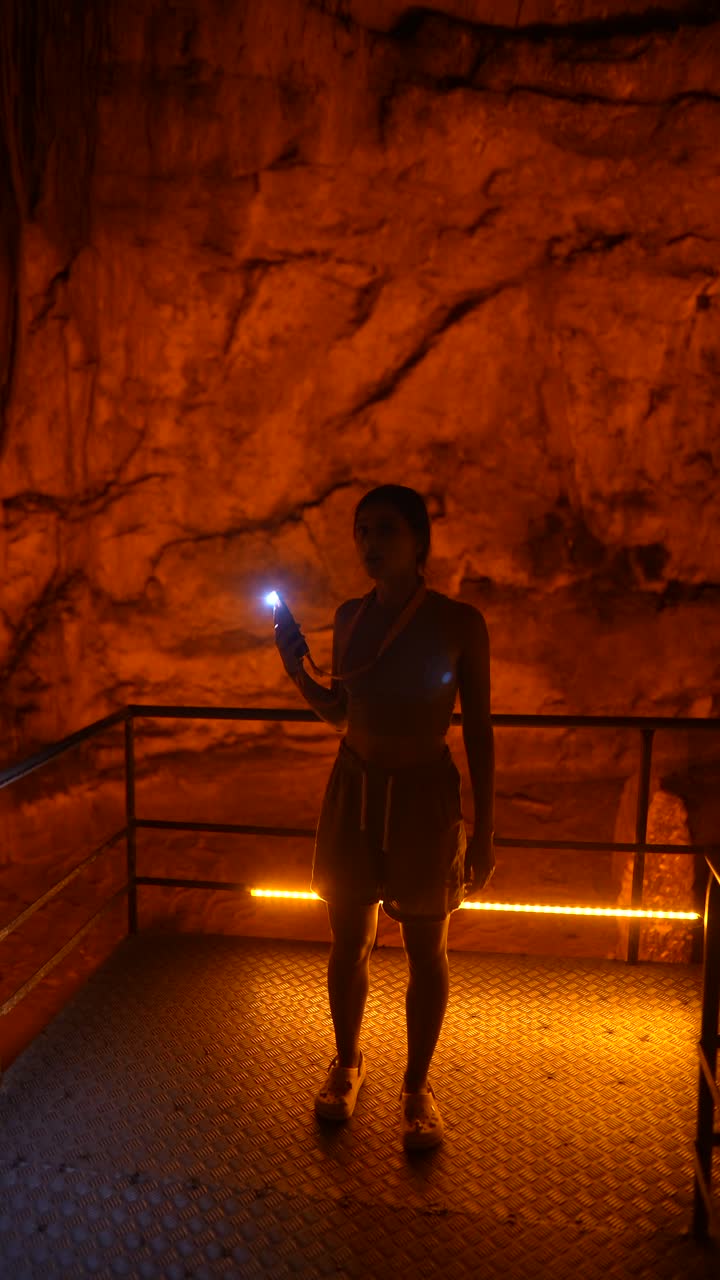 Woman Taking Pictures in a Cave