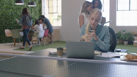 Mujer-De-Negocios-Joven-Que-Trabaja-En-Un-Proyecto-Creativo-Escribiendo-Notas-Bebiendo-Agua-En-La-Oficina-Navegando-En-Línea-Usando-Una-Computadora-Portátil