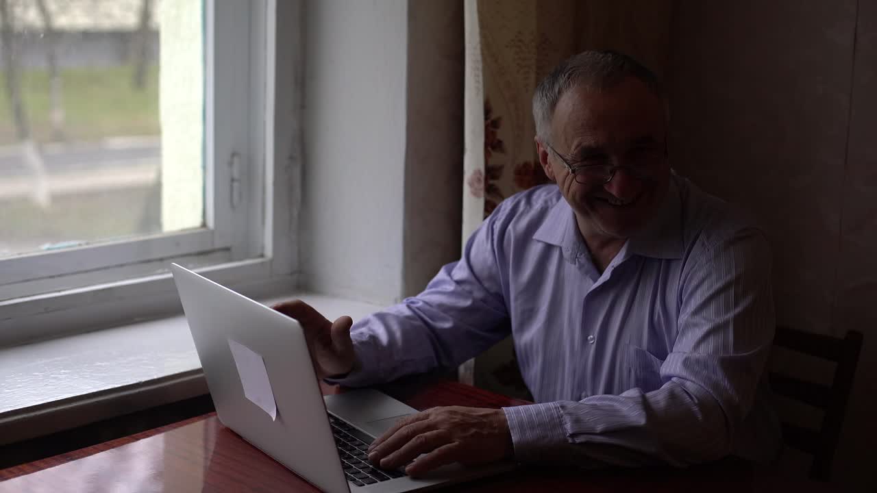 elderly man uses video call on his smartphone to communicate, safely communicate with people via video call