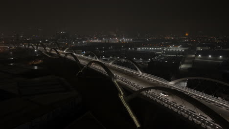 Traffic-and-cars-drive-across-downtown-Los-Angeles-6th-st-bridge-at-night