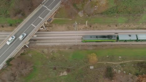 top down aerial view of the historical philip ii train heading along the train tracks and under a bridge