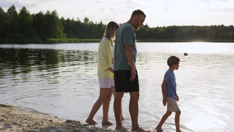 family holding hands on the beach