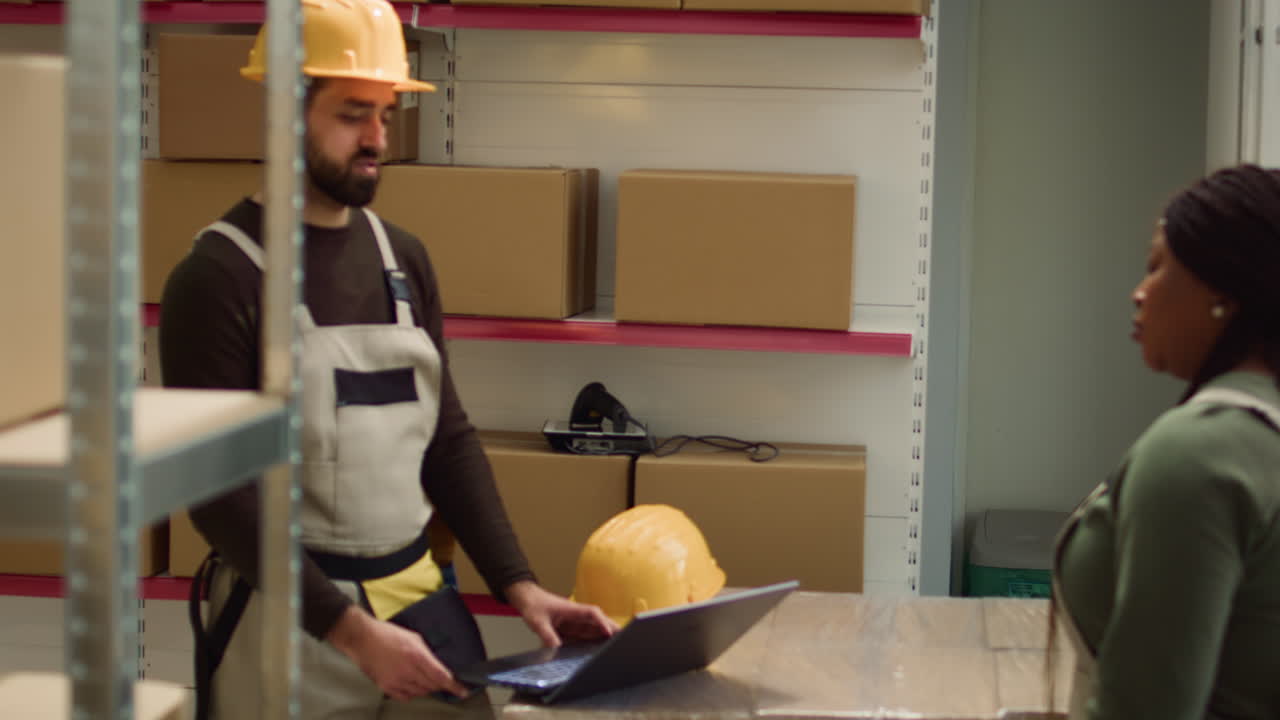 Warehouse workers with boxes and equipment