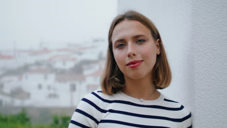 Beautiful-old-town-girl-posing-at-rooftops-vertical-closeup.-Calm-tourist-rest