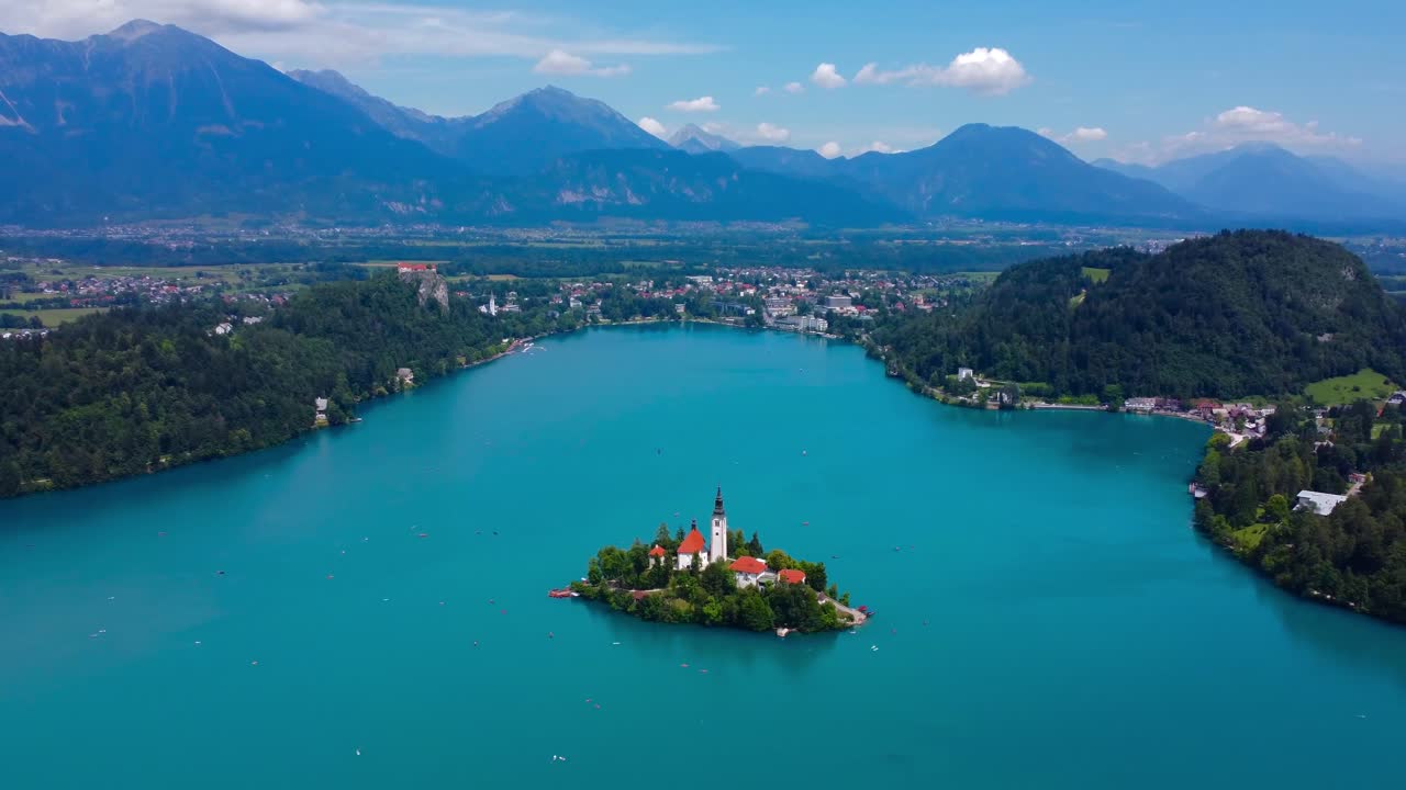 Iconic Lake Bled Island on turquoise blue lake with alps in the background - Bled Slovenia