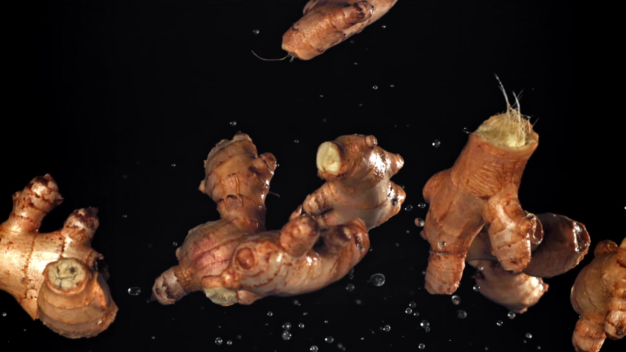 Slow Motion of Fresh Ginger Roots Falling with Water Splashes