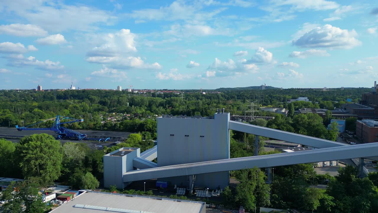 hard coal fired power station transporting coal on conveyor belts, showcasing industrial infrastructure in a city. Lovely aerial view flight ascending drone