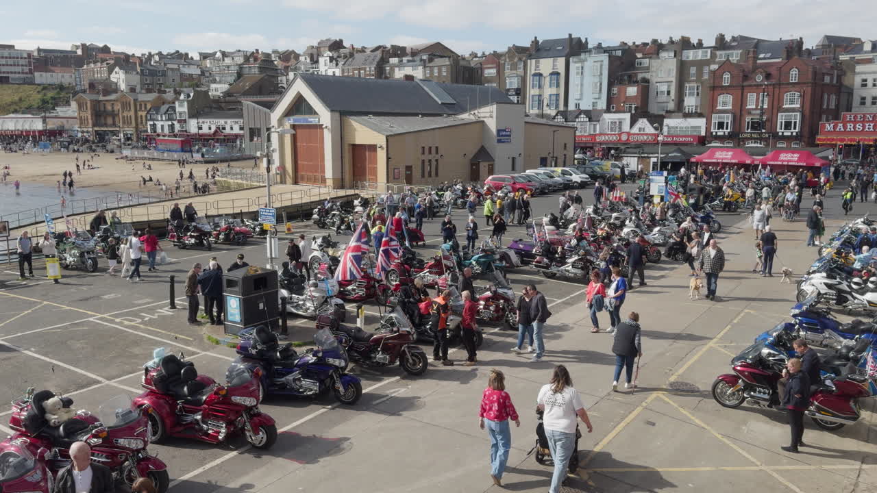 Motorcycle enthusiasts gather at Scarborough Beach, showcasing a variety of bikes and enjoying the lively atmosphere on a sunny day.