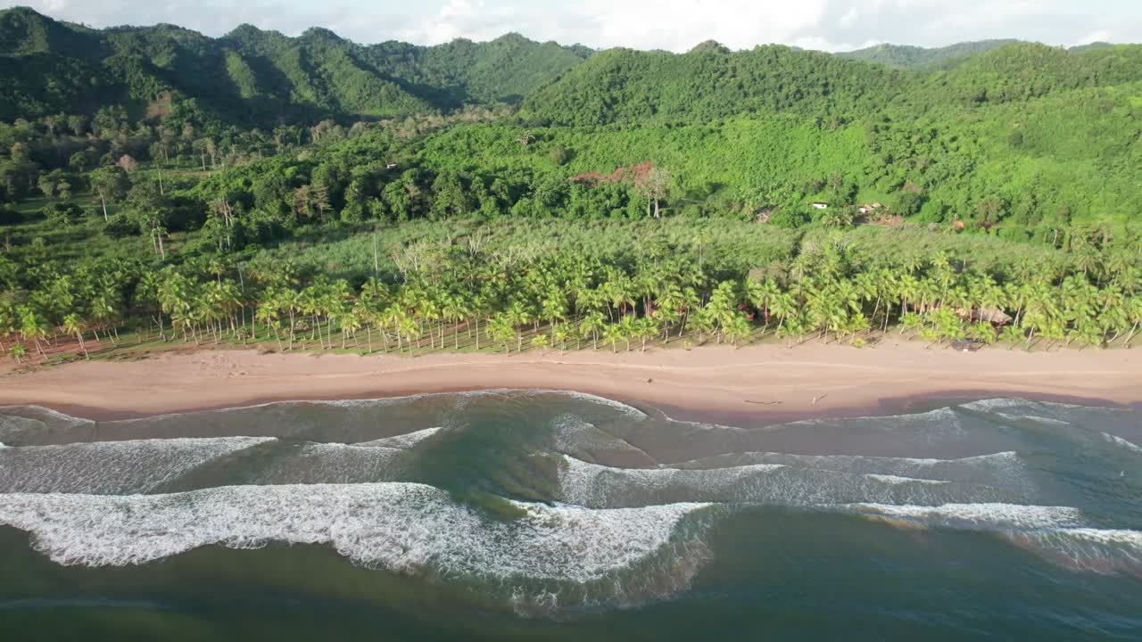 Aerial view of serene Puy Puy beachscape, lush green hills in Paria
