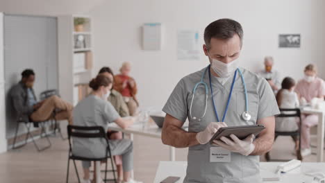 man in scrubs posing in clinic