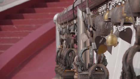 Bells Swinging in the Wind at Buddhist Temple. Focus Pull from Near to Far. Slow Motion.