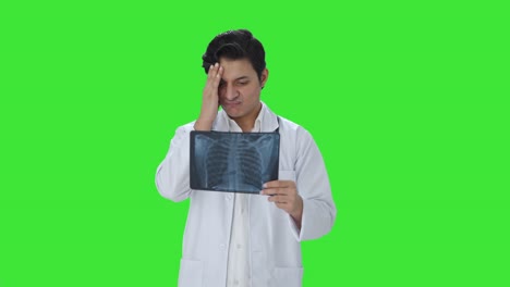 Confused-Indian-doctor-checking-X-ray-report-Green-screen
