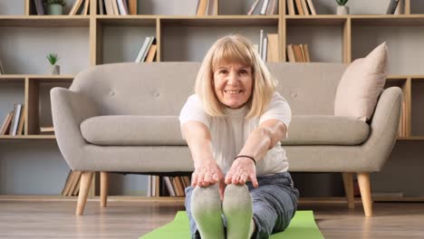 mature woman practicing meditation at home calm senior woman sitting on floor doing yoga smiling mature woman practicing meditation at home calm senior woman sitting on floor doing yoga for mental balance breathing air relaxing