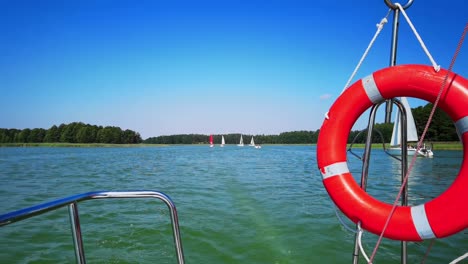 the front bow of a white sailing boat with blue sky and sea background