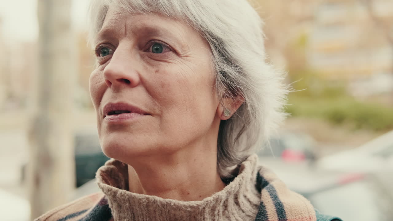 Pensive Senior Woman with Grey Hair Looking Away Outdoors