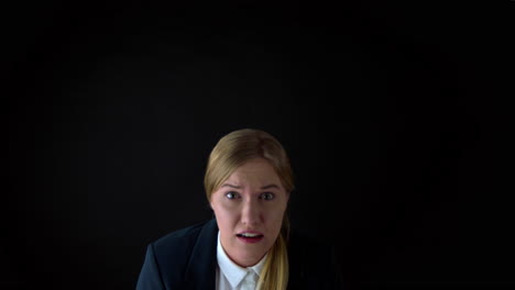 terrified woman on black background