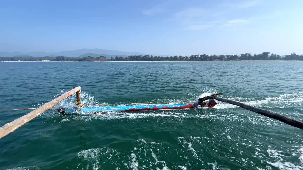 Close up shot of oars of traditional fishing boat at ocean, mountain in the horizon Goa in India 4K