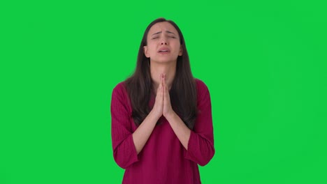 scared indian woman praying to god green screen