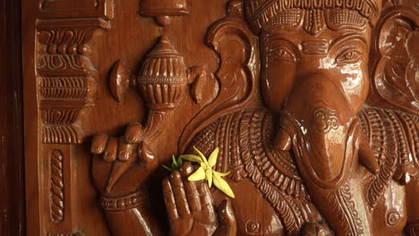 lord ganesh holding a flower