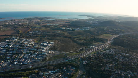 Highway-motorway-tolls-Montpellier-aerial-shot-mediterranean-sea-industrial-area