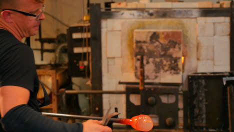 glassblower shaping a molten glass