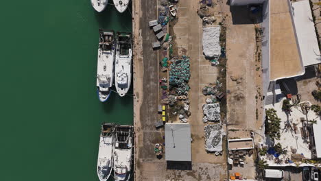 top-down view of boats docked along marina strip with parallel moorings and paths