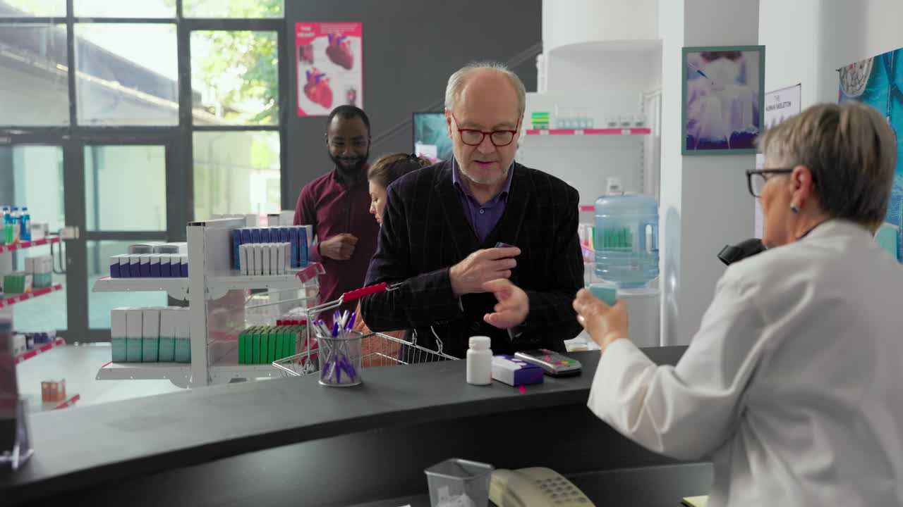 People in a pharmacy interacting with a pharmacist
