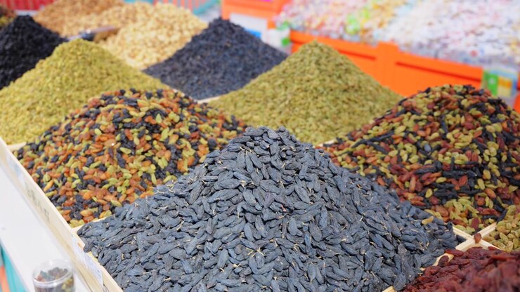 Assorted Xinjiang dried fruits displayed in local specialty shop
Multi-color raisin piles and jujube from Yining China
Closeup view of natural preserved berry and grape snacks
