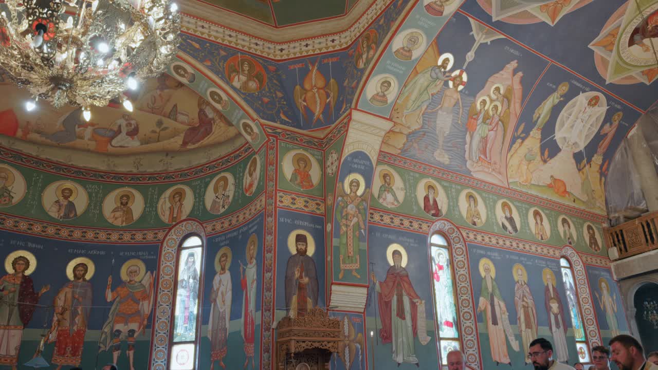 Interior Of An Orthodox Church With Paintings On Walls And Ceilings - Tilt Up Shot