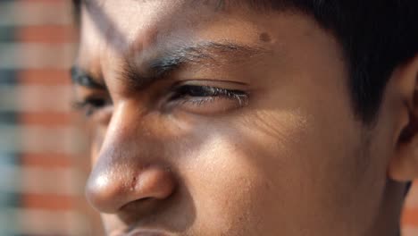 close-up portrait of a young man looking away