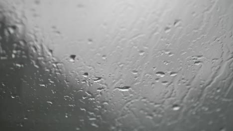 Water-tracks-from-rain-on-a-glass-window---close-up