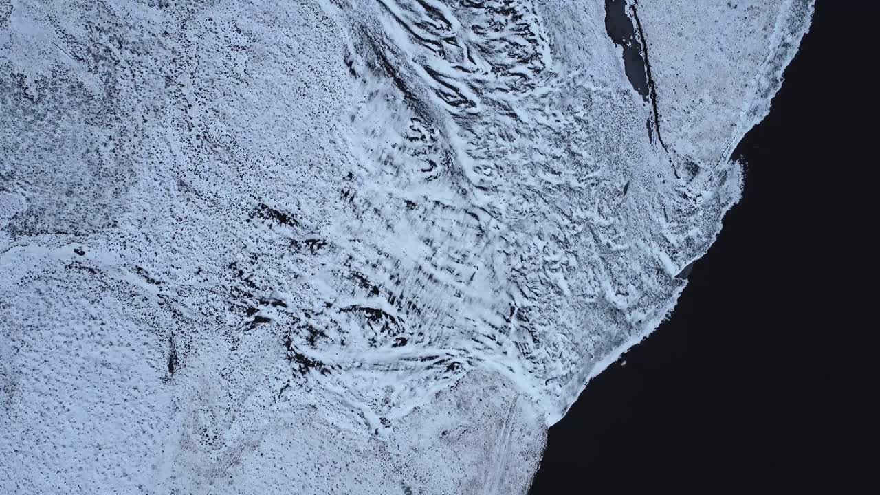 Snowy shore of cold sea