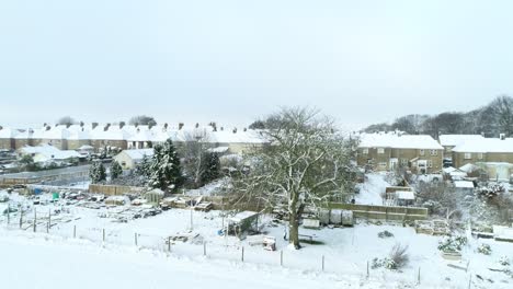 Snowy-small-town--rooftops-from-drone