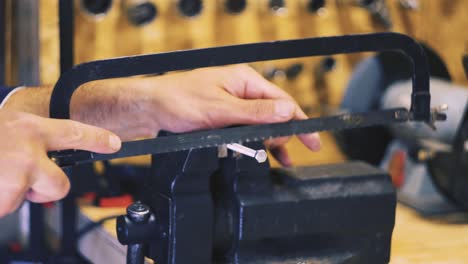 male hands sawing a bolt