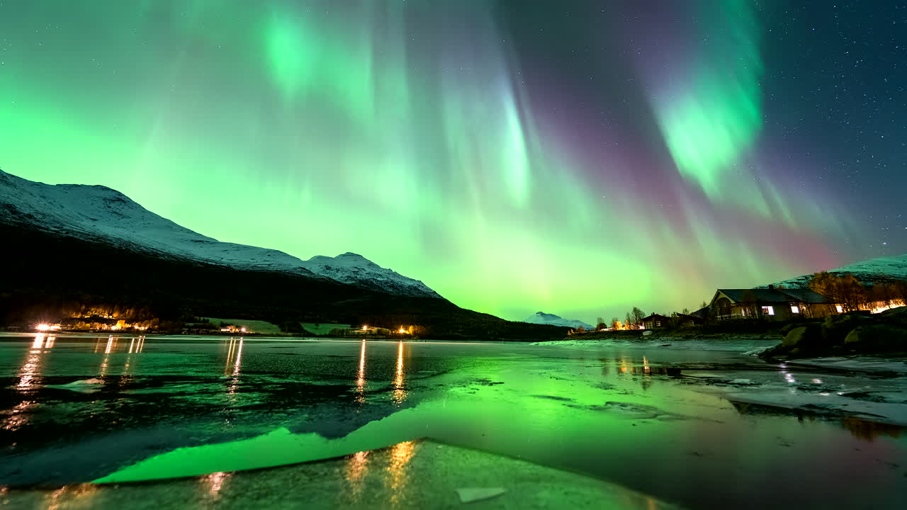 Northern lights dance in night sky over Lakselvbukt with rising tide, timelapse