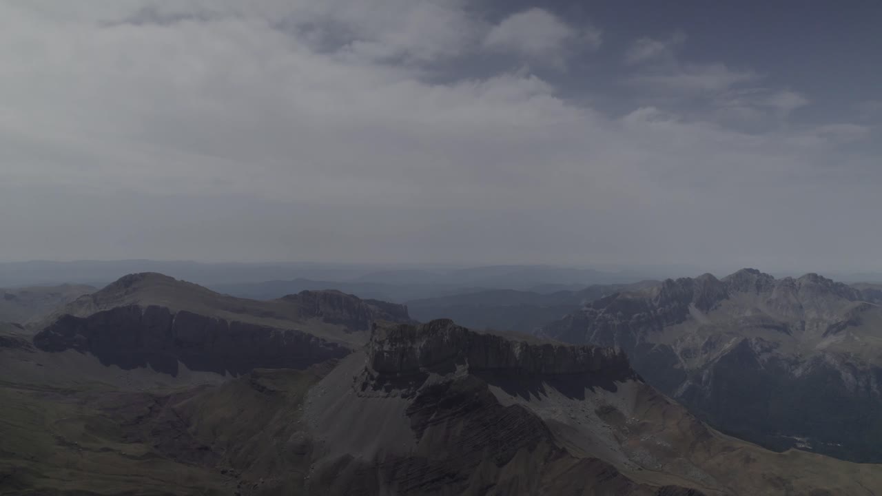 This drone video showcases a stunning frontal descriptive shot facing the majestic Pico del Castillo d’Acher in the Aragonese Pyrenees, Spain, capturing breathtaking mountain scenery.