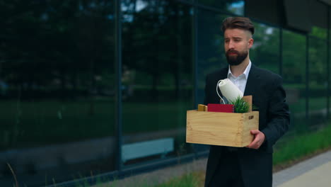 unemployed businessman carrying his belongings